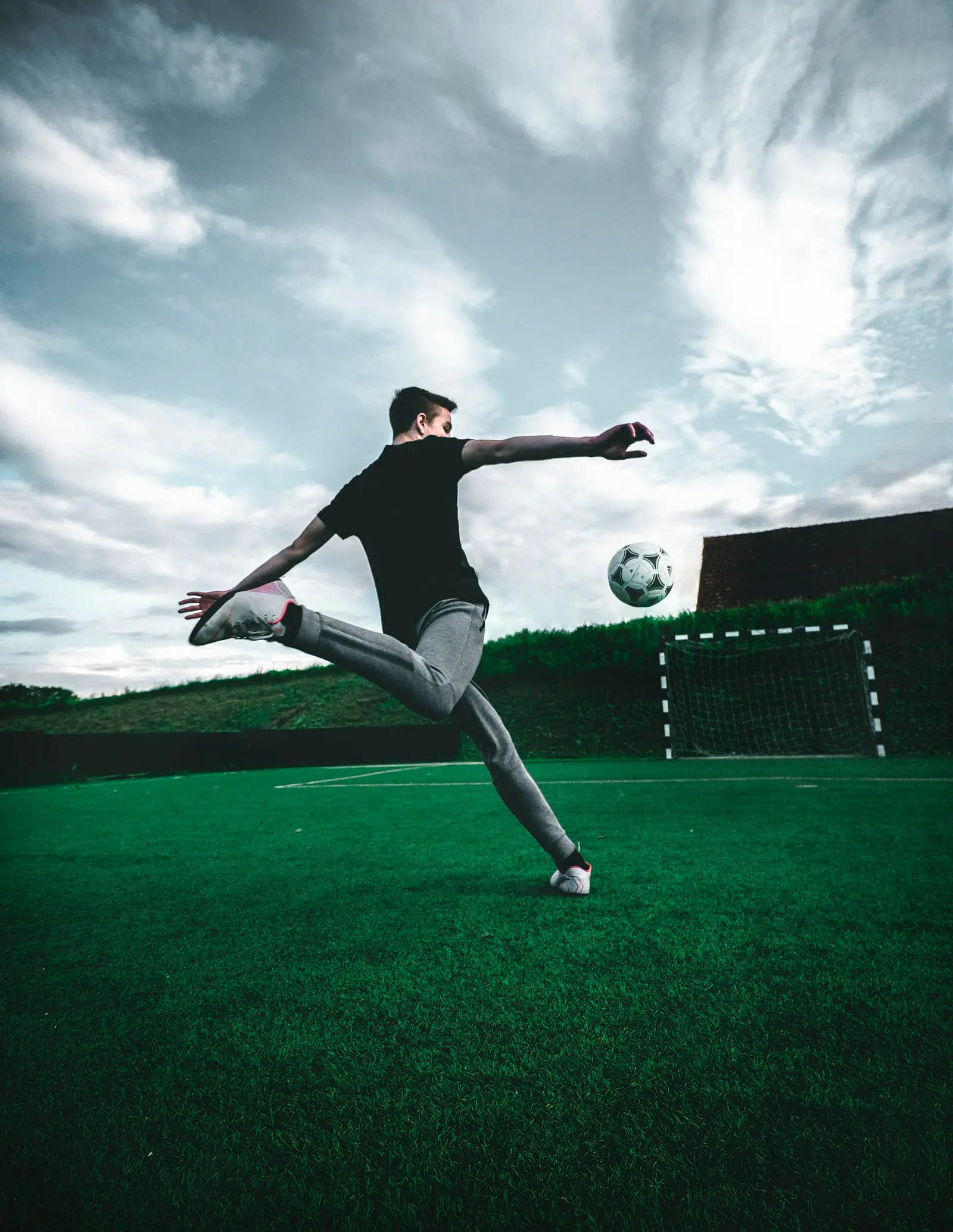 Young people playing football together with energy and focus